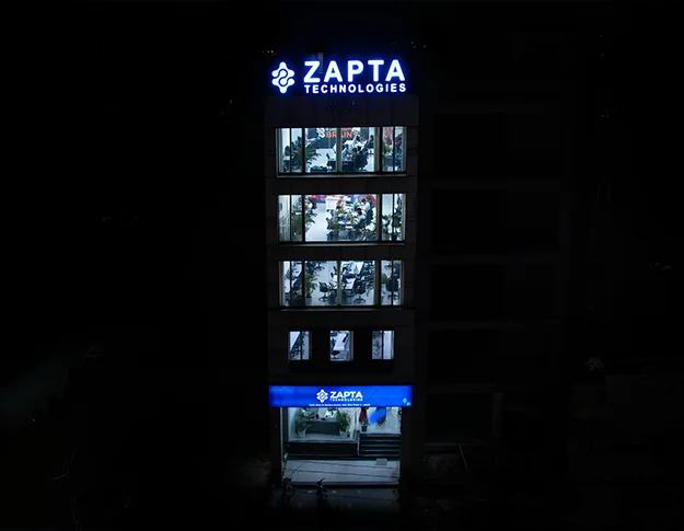 A team of software developers working in the Budget Trips LTD office building in Lahore, Pakistan. The developers are working on a custom software development project, using various tools and technologies to create a high-quality software solution. The image is relevant to the keywords "about us," "custom software development company," "web development company," "mobile app development company," "application development company," "IT consulting company," "IT services company," "IT solutions company," "IT outsourcing company," "quality assurance," "mobile apps," "data analytics," "artificial intelligence," "machine learning," "MVP builder," "dedicated teams," "history of Budget Trips LTD," and "Budget Trips LTDoffice building."